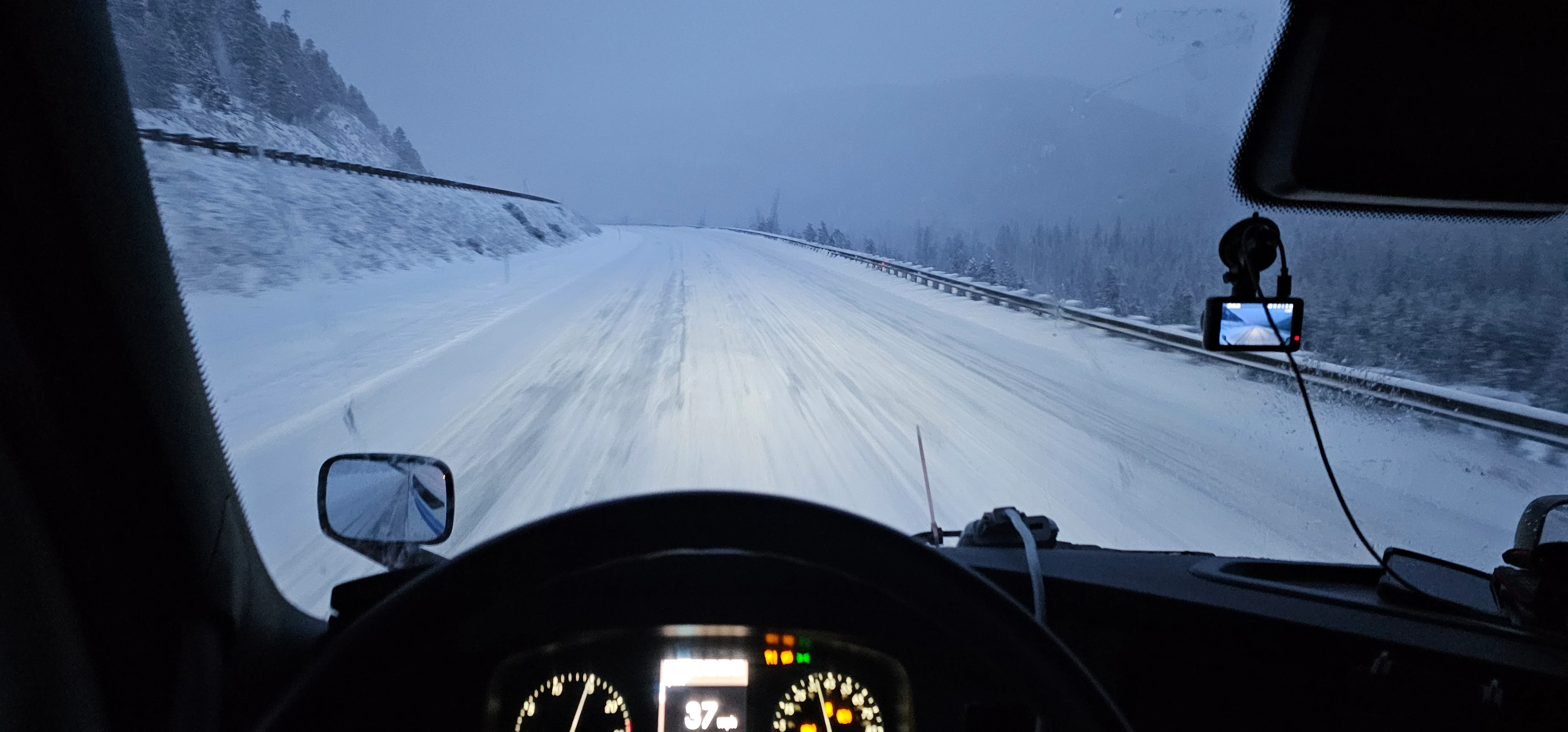 winter snowy roadway with tire tracks